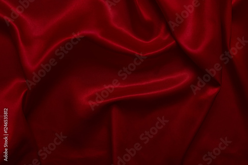 The top view of the red satin surface looks luxurious and beautiful. with sparkling waves Abstract background design copy space Card or banner (blurred or blurry)