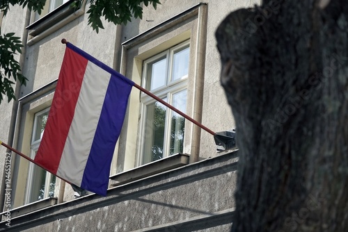 Flag with red, white and blue stripes on flagpole