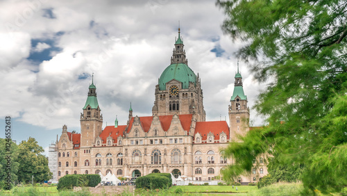 Hyperlapse of Hanover's New Town Hall, a landmark castle-like structure surrounded by park and lake under a cloudy sky. Germany photo