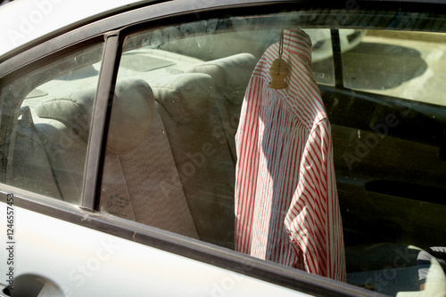 Red and white striped male shirt hanging in the back of a car. Israel photo