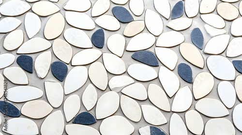 Abstract pattern of small, leaf-shaped tiles in cream, white, and dark grey. Background A surface of mosaic tiles. Potential use Design inspiration, architectural design photo