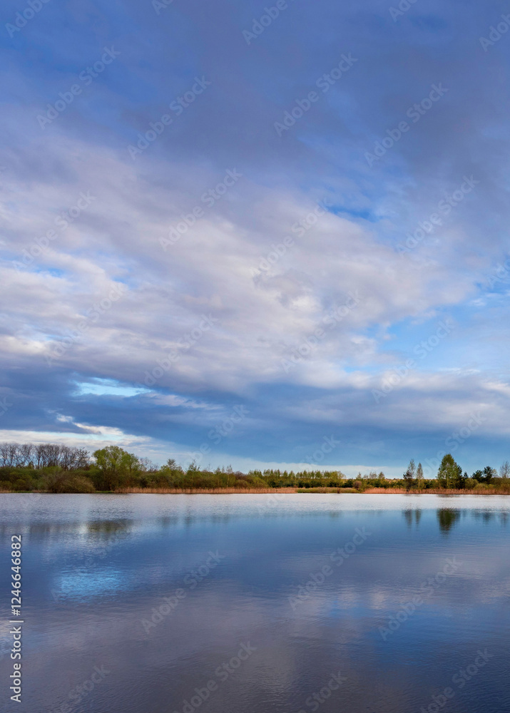 Calm lake with a cloudy sky in the background