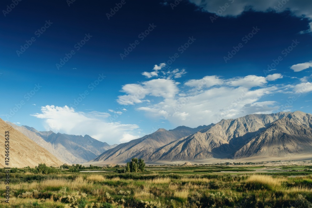 Fototapeta premium Panoramic view of majestic mountain ranges under a clear blue sky during midday