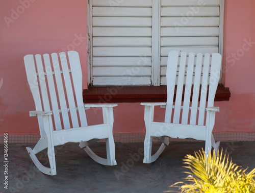 multiple vintage rocking chairs in front of colorful wall