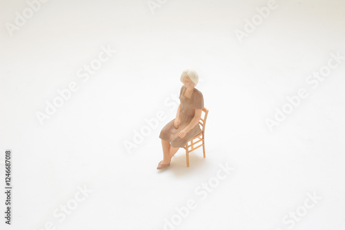 Schilderij op canvas Small Figure of a Woman Sitting on a Chair