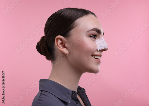 Foto Woman with medical bandage on her nose after plastic surgery operation against p