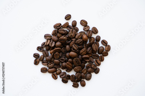 a small pile of Arabica and Robusta coffee beans lies on a white background