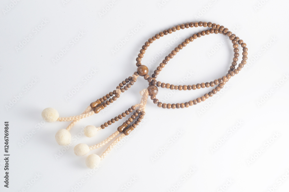 Obraz premium A wooden Juzu, a Japanese prayer beads, is a form of beadwork used to count the repetition of prayers, chants or mantras by members of various religions such as Buddhism and Shinto.