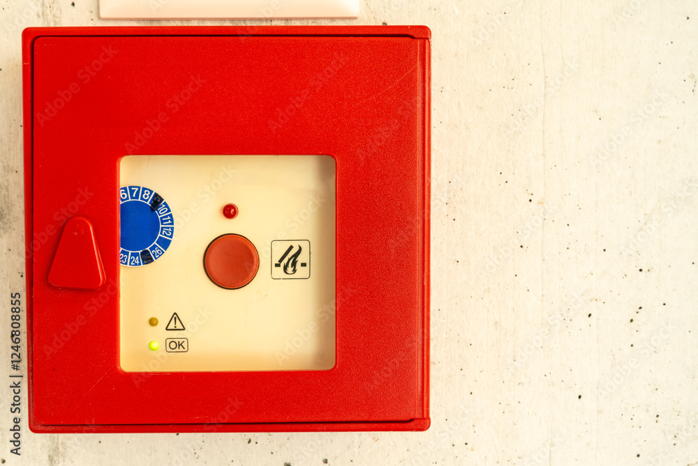 Red fire alarm box on the wall. Service badge inside. Red fire alarm box on the wall. Service badge inside.