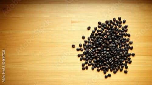 A scattering of roasted coffee beans on a light wood surface provides a natural, warm background for culinary or beverage-related projects.