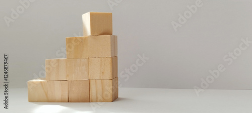 Building blocks stacked in ascending order minimalist studio photography modern close-up concept of growth