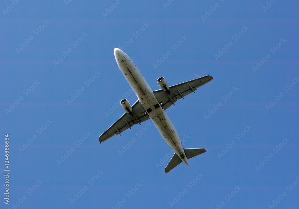 bottom view of a plane in the sky bottom view of a plane in the sky