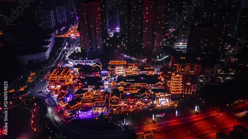 Chongqing Ancient Town illuminated at night with traffic delays on the main road