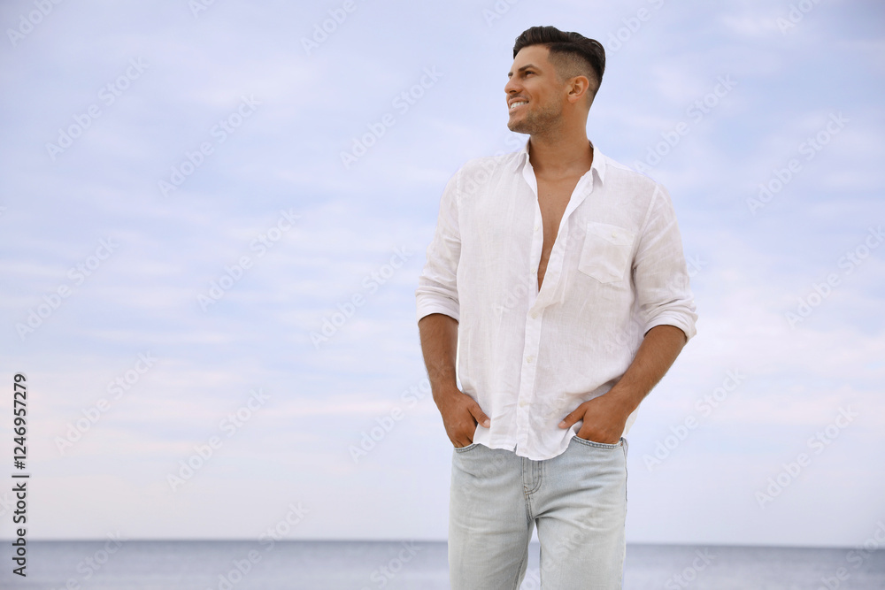 Handsome man on beach near sea. Space for text Handsome man on beach near sea. Space for text