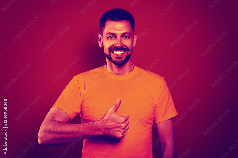 Obraz premium Happy man showing thumbs-up in neon light