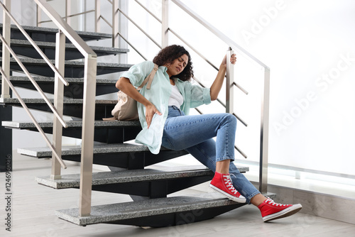 Konstfotografi Woman with injured back on stairs in building after fall