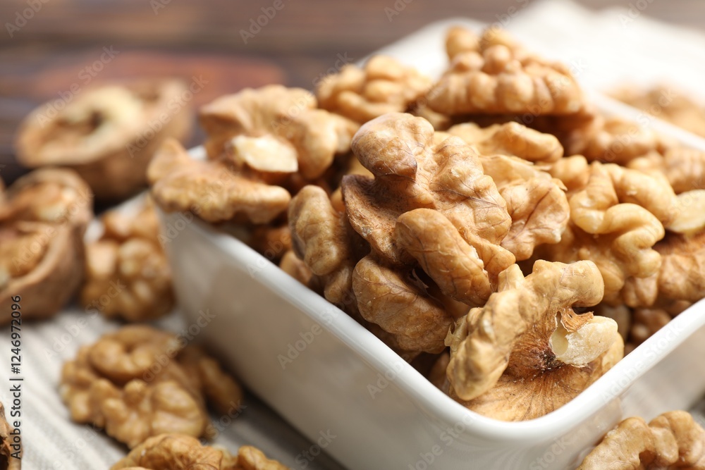 Peeled walnuts in bowl on table, closeup Peeled walnuts in bowl on table, closeup
