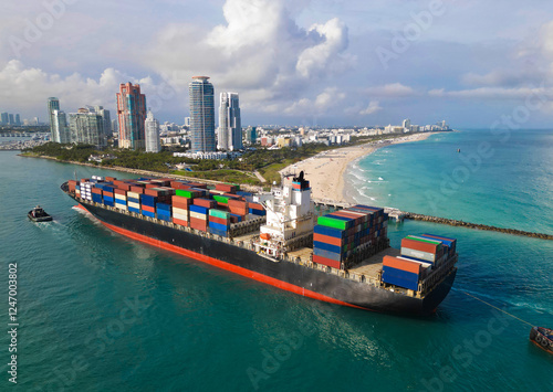Container ship. Export and import. Cargo business. Port of Miami. Cargo ship with container in Miami, aerial. Freight container on cargo vessel. Cargo ship vessel leaving port. Efficient transport