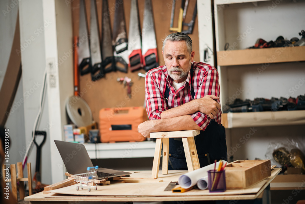 Senior male carpenter working on detailed woodwork design in a factory, utilizing craftsmanship and tools to create furniture while collaborating with coworkers in a woodworking workshop. Senior male carpenter working on detailed woodwork design in a factory, utilizing craftsmanship and tools to create furniture while collaborating with coworkers in a woodworking workshop.