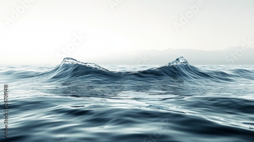 Ocean waves gently rolling under a hazy sky at dawn along a tranquil coastline