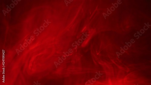 Wisps of red smoke and light swirling on black background