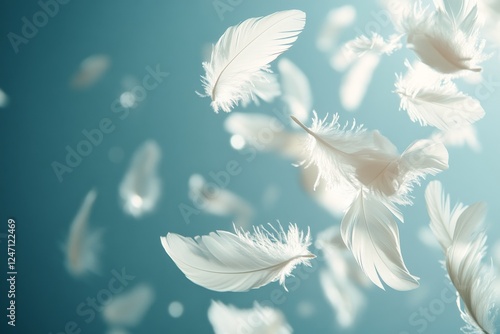 Soft white feathers floating gracefully in a serene blue background