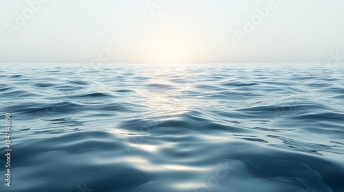 Ocean waves gently rolling under a hazy sky at dawn along a tranquil coastline