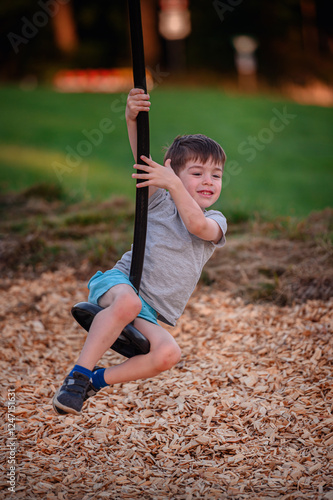 Young boy enjoying zip line ride at playgroundboy