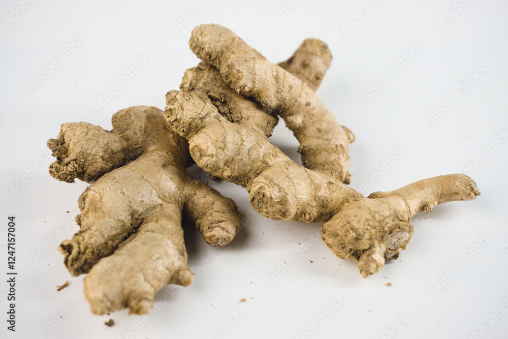 Fresh and Organic Ginger Roots Isolated on a White Background Fresh and Organic Ginger Roots Isolated on a White Background