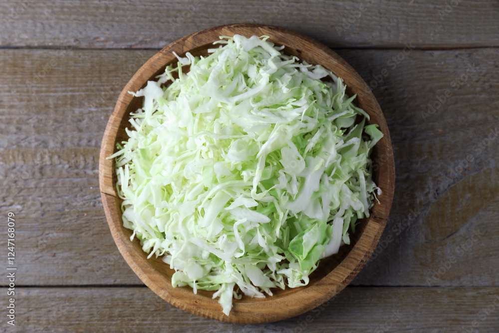Fresh shredded cabbage on wooden table, top view Fresh shredded cabbage on wooden table, top view