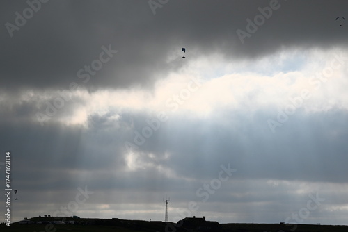 beechy head Eastbourne with a dramatic sky and paragliding in the background photo