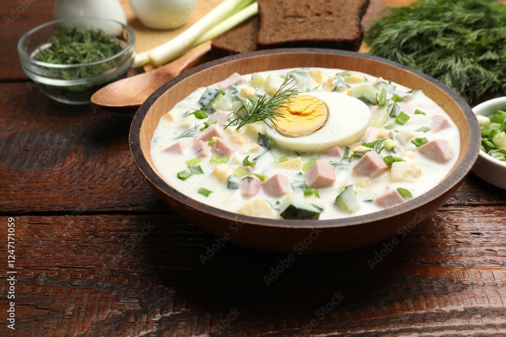 Delicious okroshka soup with kefir served on wooden table, closeup Delicious okroshka soup with kefir served on wooden table, closeup