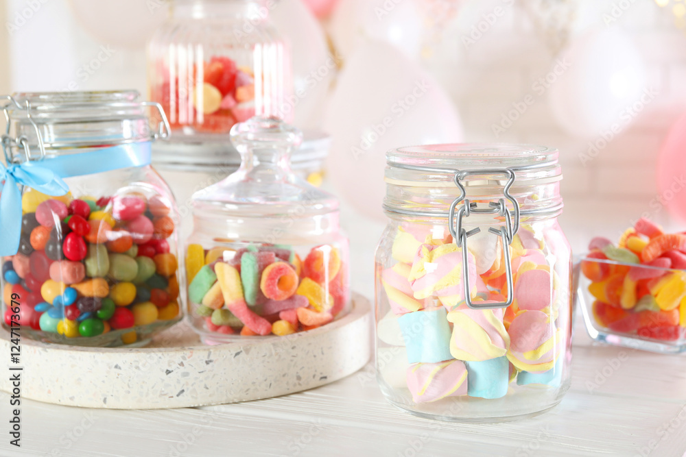 Candy bar. Many different sweets on white wooden table indoors Candy bar. Many different sweets on white wooden table indoors