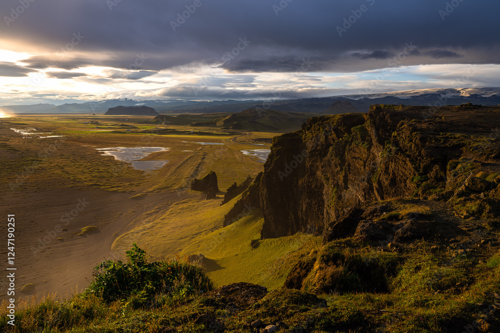 The golden hour of sunset over the Dyrholaey peninsula, in Iceland The golden hour of sunset over the Dyrholaey peninsula, in Iceland