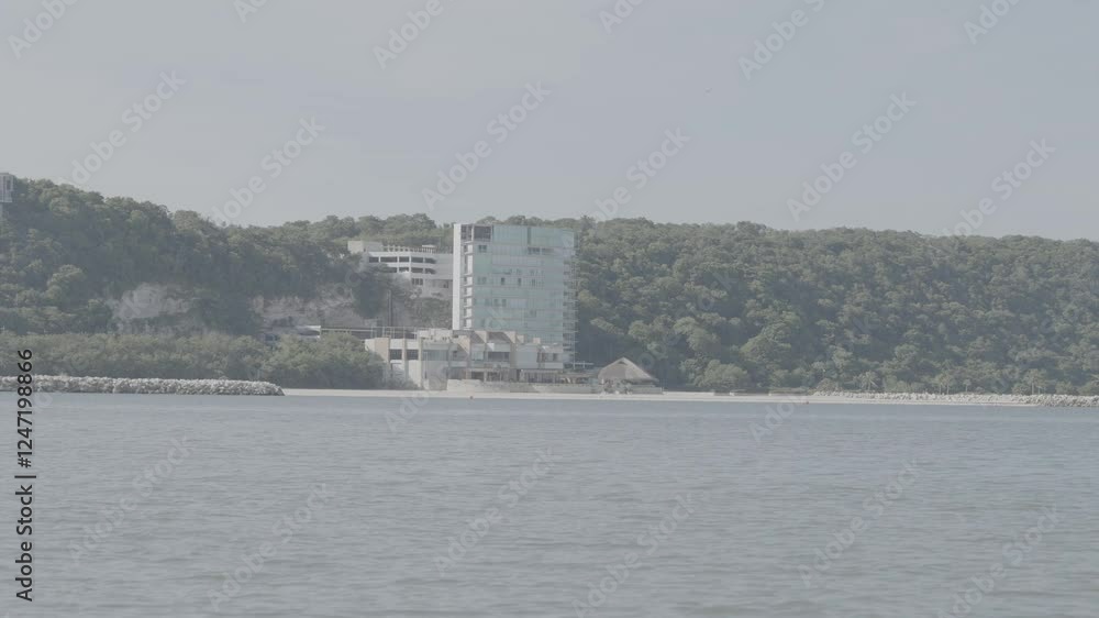 A building on the beach from the perspective of a passing boat A building on the beach from the perspective of a passing boat