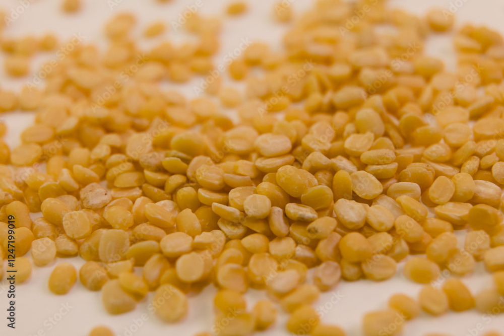 Dried yellow split peas scattered on a surface ready for cooking or use Dried yellow split peas scattered on a surface ready for cooking or use