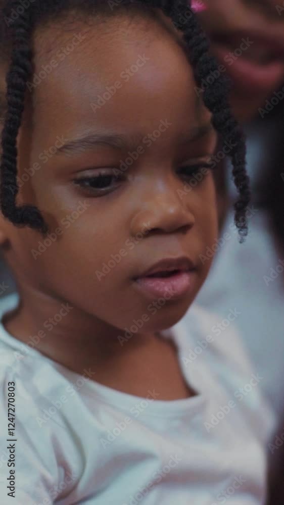A charming video shows a smiling girl with braids, exuding joy A charming video shows a smiling girl with braids, exuding joy