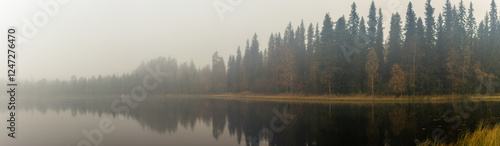 Quadro su tela Misty Morning Over Calm Lake Reflecting Dense Forest and Autumn Foliage in Seren