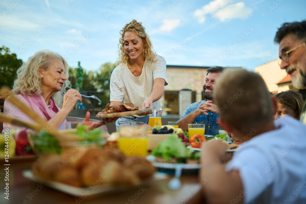 Happy family having lunch together on a sunny day Happy family having lunch together on a sunny day