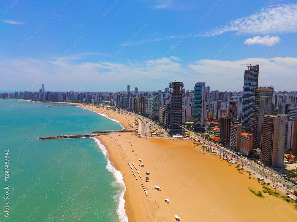 Aerial shot of Iracema Beach in Fortaleza, Ceara, Brazil. Natural beauty with golden sand and turquoise sea Aerial shot of Iracema Beach in Fortaleza, Ceara, Brazil. Natural beauty with golden sand and turquoise sea