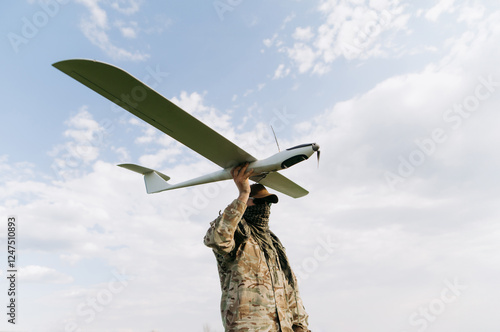 unmanned aerial vehicle in the hands of a soldier. Launching a drone for reconnaissance purposes