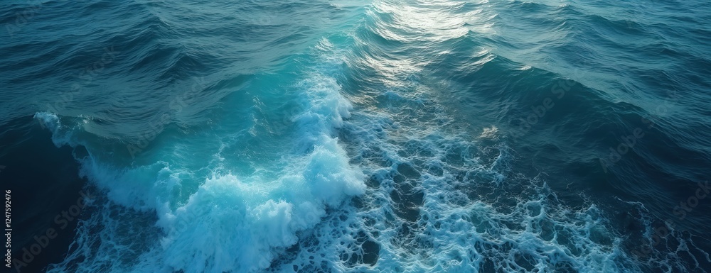 Ocean water surface with waves. Blue water background with white foam. Natural light creates beautiful colors. Sea water texture. Stunning aquatic scene. Perfect for travel, nature, tropical, summer Ocean water surface with waves. Blue water background with white foam. Natural light creates beautiful colors. Sea water texture. Stunning aquatic scene. Perfect for travel, nature, tropical, summer