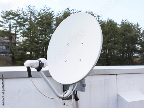 Fotografie Parabolic antenna fixed to balcony.
