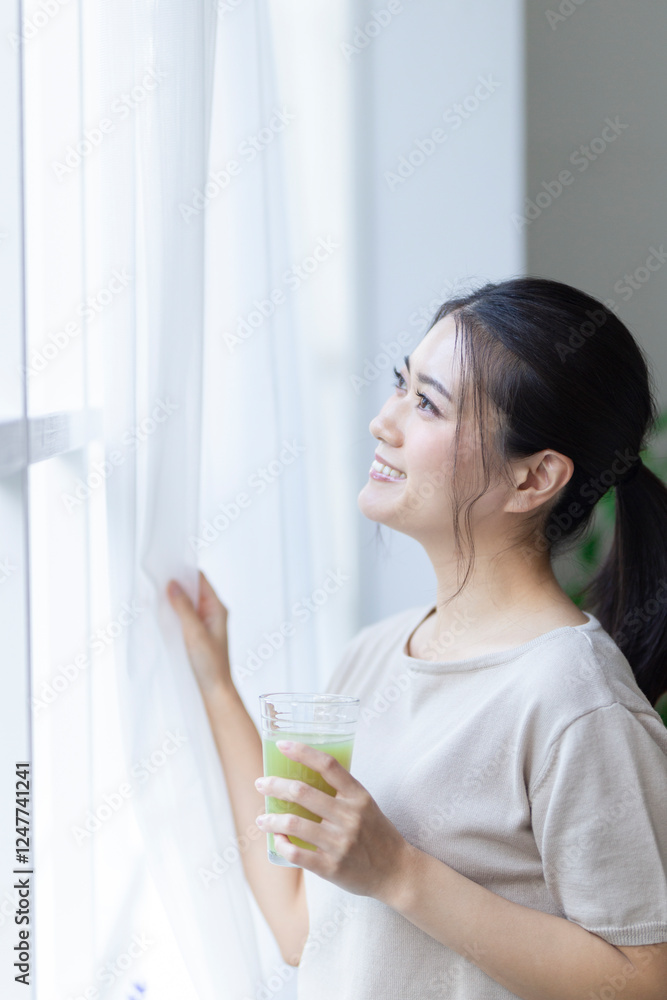 窓の外を眺める女性 窓の外を眺める女性
