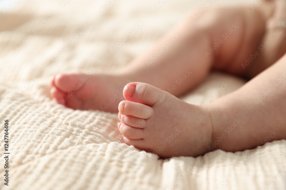 Little baby lying on bed indoors, closeup Little baby lying on bed indoors, closeup