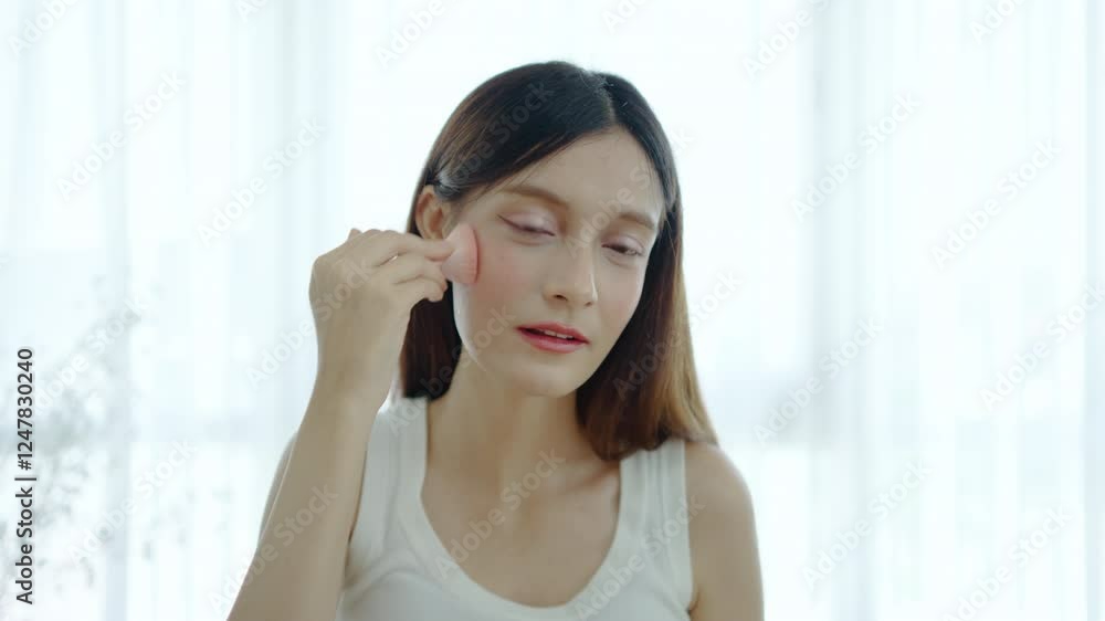 Young mixed race woman stands before a mirror, carefully applying her makeup and applying blush. The bright room creates a lovely, she prepares for the night, showcasing her dedication to beauty Young mixed race woman stands before a mirror, carefully applying her makeup and applying blush. The bright room creates a lovely, she prepares for the night, showcasing her dedication to beauty