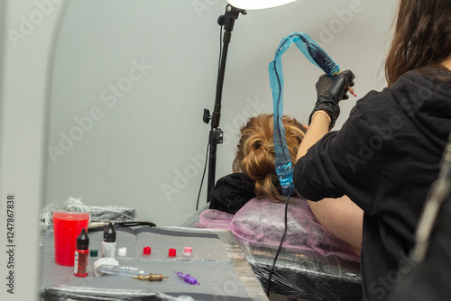 details, paints, hands in gloves. Tattoo artist at work photo