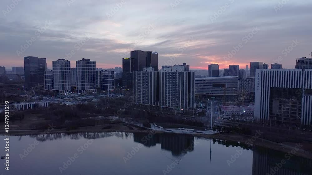 Twilight view of Zhengzhou Zhengdong New District showcasing Longzi Lake and emerging city skyline Twilight view of Zhengzhou Zhengdong New District showcasing Longzi Lake and emerging city skyline