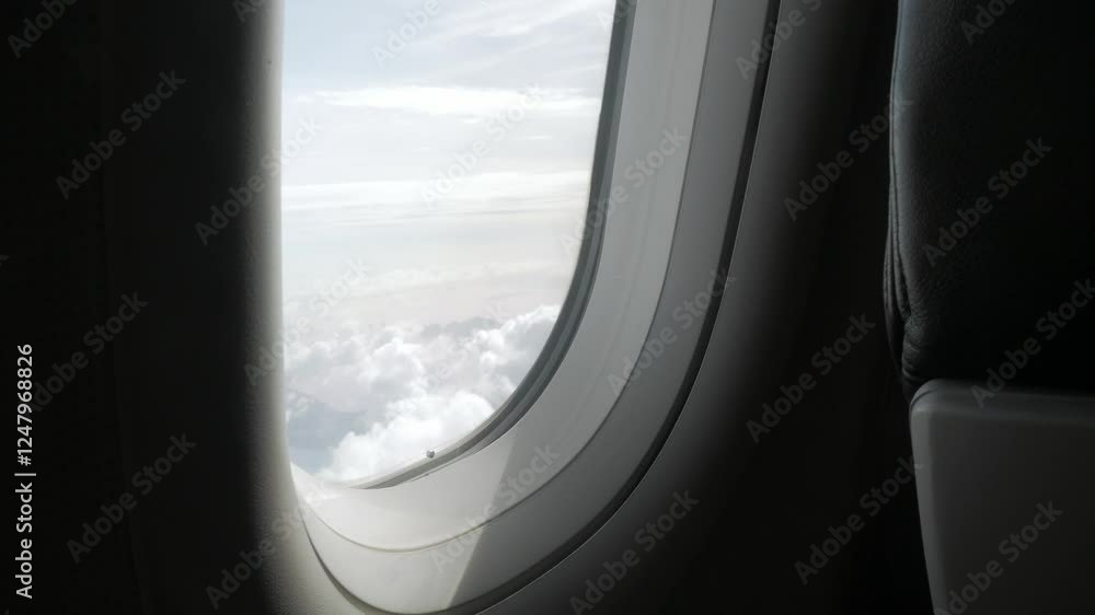 through the window of the airplane from inside cabin while flyiing climbing into the sky above the cloudscape outside in summer day,natural transportation holiday vacation background through the window of the airplane from inside cabin while flyiing climbing into the sky above the cloudscape outside in summer day,natural transportation holiday vacation background