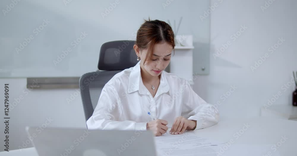 A dedicated student immerses in studies showcasing focus and productivity in a modern office setting. A dedicated student immerses in studies showcasing focus and productivity in a modern office setting.